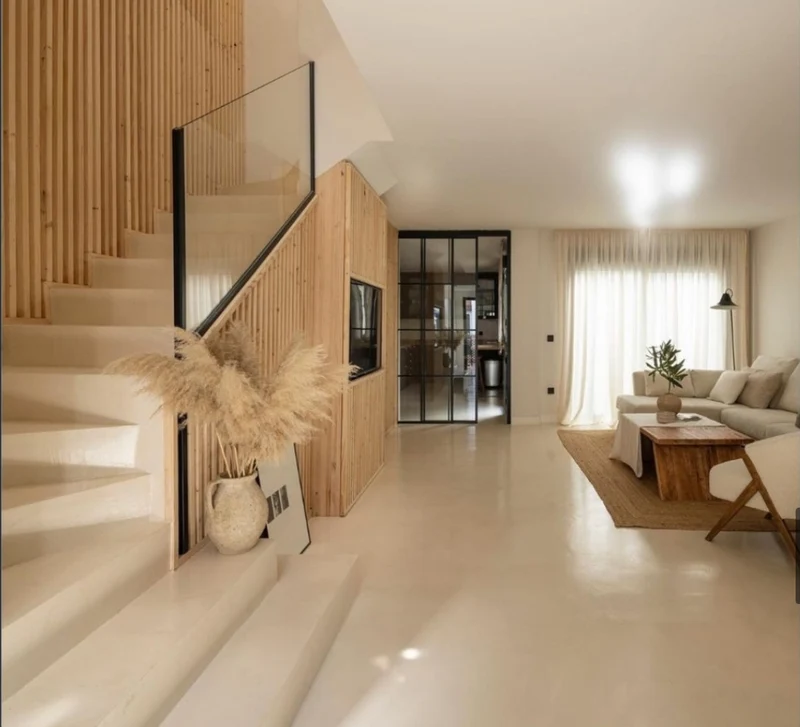 Ivory cream satin sheen microcement entry hall and staircase in Park City, Utah with timber slat wall